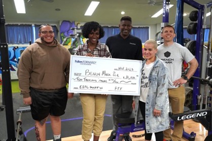 A group of Benchmark employees receiving a check from Fulton Bank